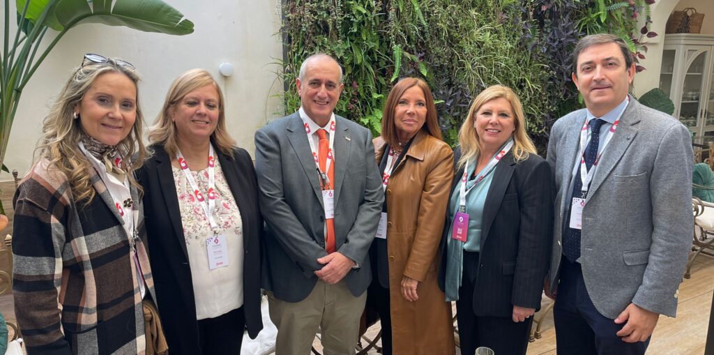 Cuatro mujeres y dos hombres posan de pie, mirando a cámara